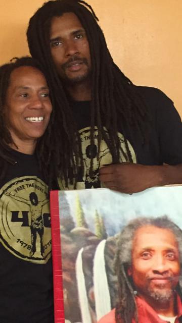 Debbie Africa, with son Mike Africa Jr. with photo of still imprisoned husband/father Mike Africa Sr